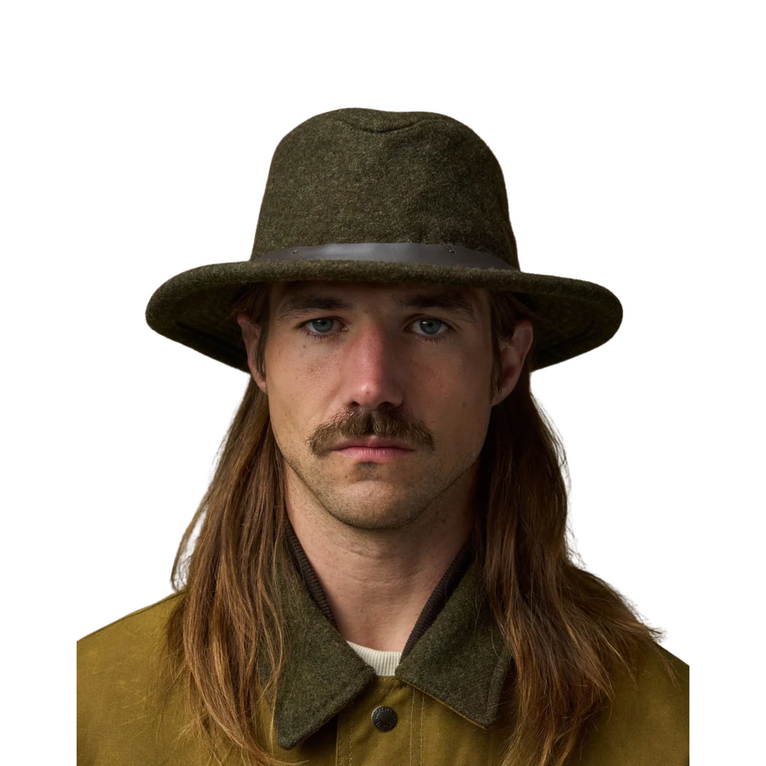 Filson Men's Mackinaw Wool Packer Hat - Forest Green on a male model on a white background.