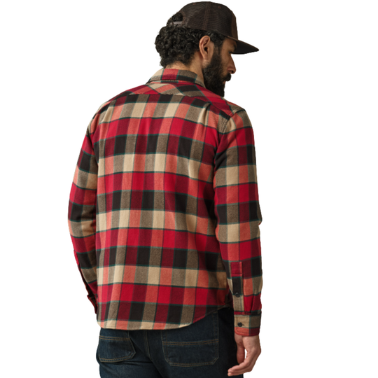 Man wearing a red and black plaid shirt with a brown cap on a white background