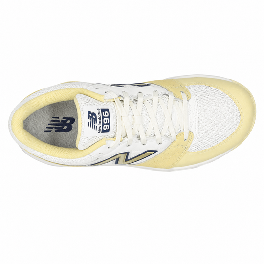 White and yellow sneaker with New Balance logo on a white background
