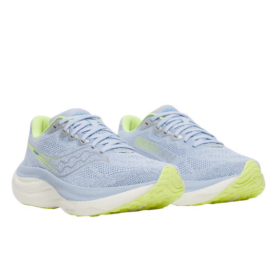 Light blue running shoes with green soles on a white background