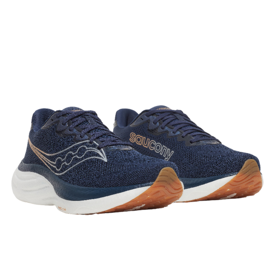 Pair of blue Saucony running shoes with brown soles on a white background