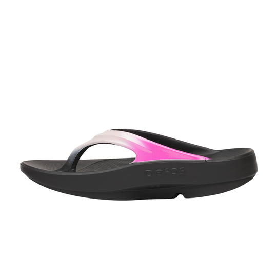 Black sandal with pink toe strap on a white background