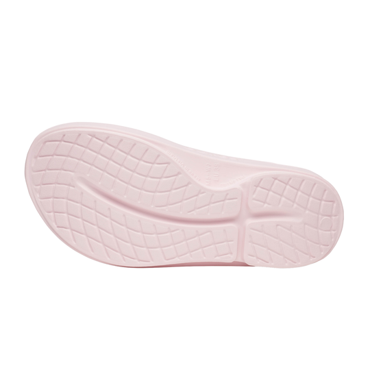 Pink sandal sole with tread pattern on a white background