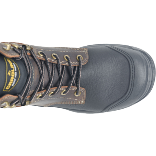 Close-up of a black and brown work boot with visible branding on a white background