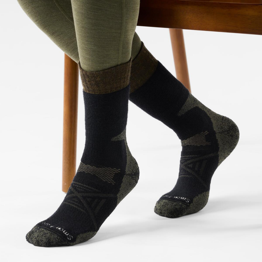 Person wearing black socks with a white background