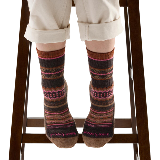 Person wearing patterned socks on a white background