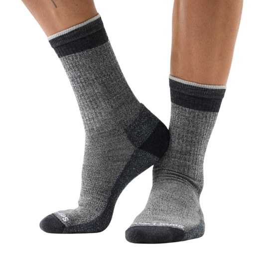 Gray socks with black accents worn by a person on a white background