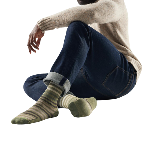 Person wearing striped socks with a neutral background
