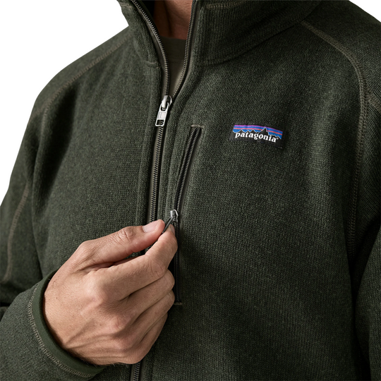 Patagonia Men's Better Sweater Fleece Jacket - Old Growth Green on a male model on a white background. Zoomed in on zipper chest pocket.