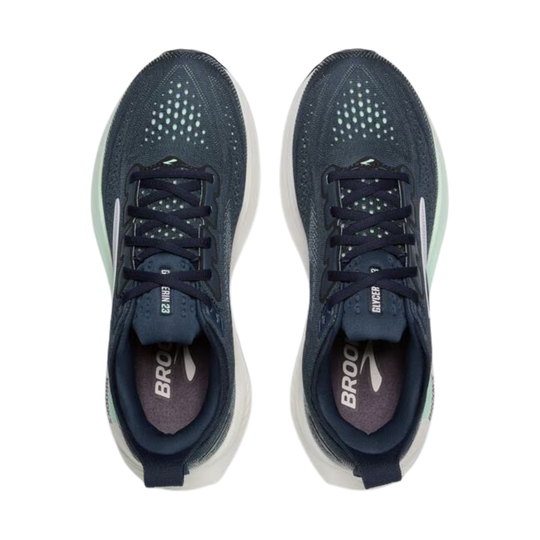 Pair of navy blue running shoes with white soles on a white background