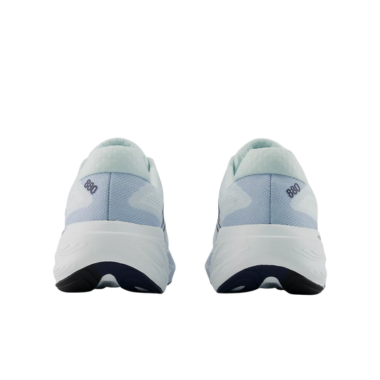 Pair of light blue athletic shoes with white soles on a white background