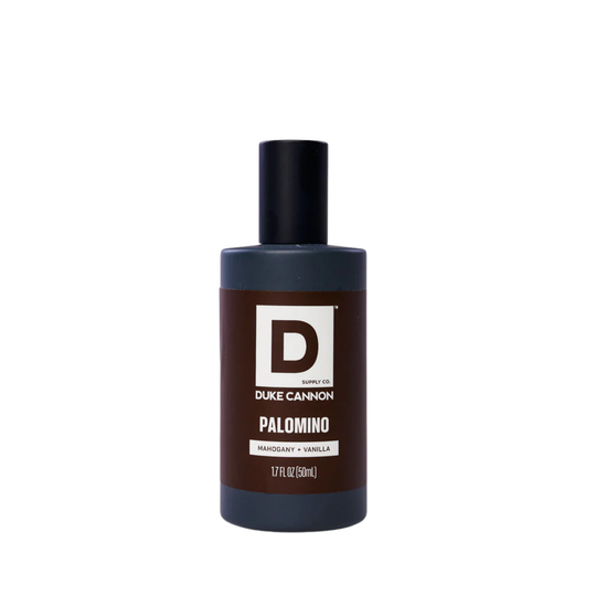 Brown cologne bottle with black cap and a large D label on a white background