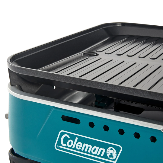 Coleman portable grill with a black grilling surface on a white background