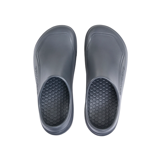 Pair of gray rubber boots with textured sole on a white background