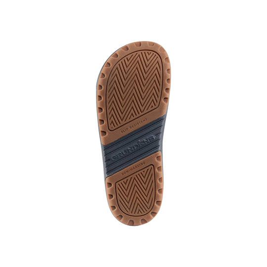 Close-up of a sandal sole with brown leather and blue insole on a white background