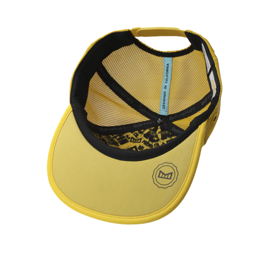 Yellow visor cap with black mesh and leopard print details on a white background