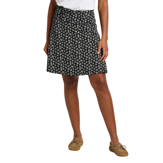 Person wearing a black floral skirt on a white background
