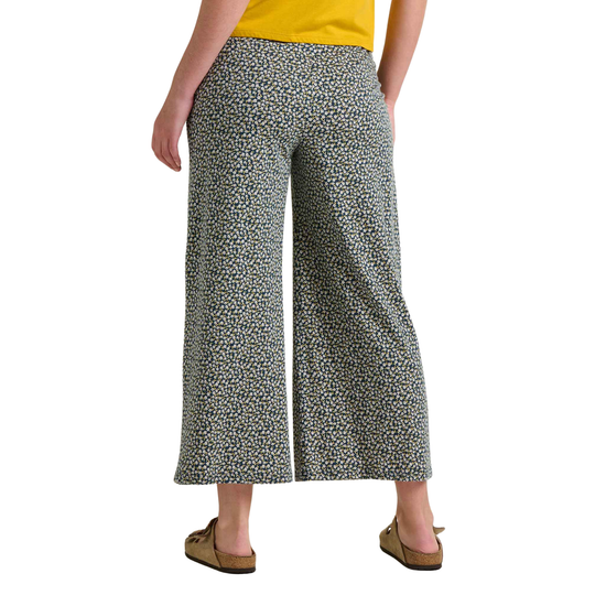 Person wearing patterned wide-leg pants on a white background
