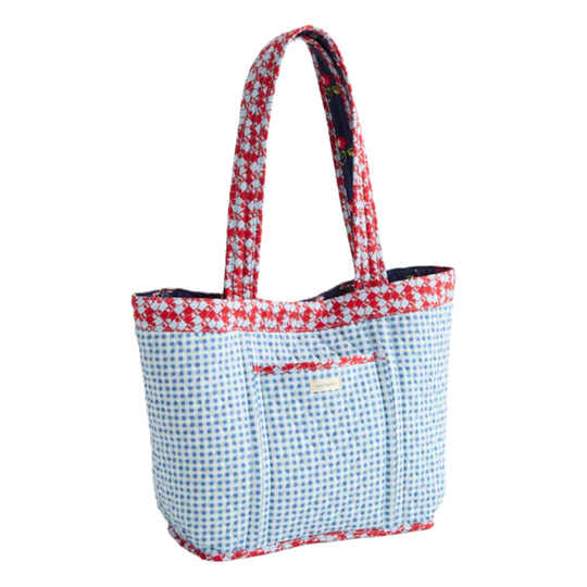 Tote bag with red floral top handle and blue checkered body on a white background