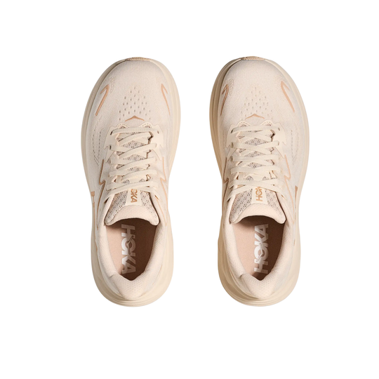 Pair of beige running shoes with laces and mesh uppers on a white background