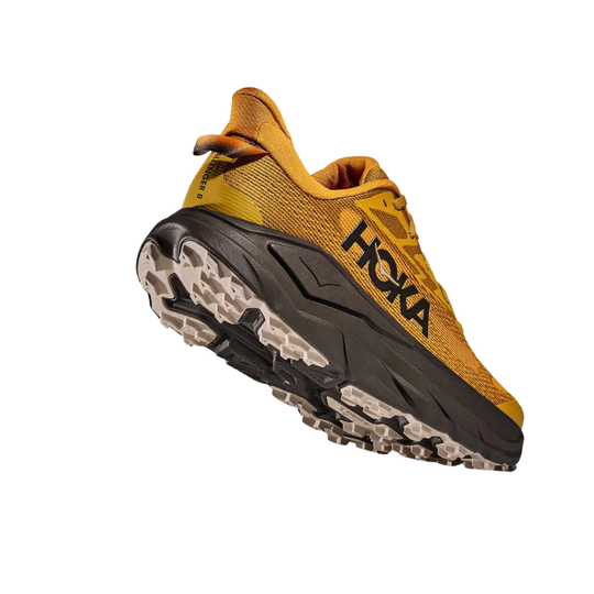 Yellow trail running shoe with black midsole, rugged outsole, and visible HOKA logo