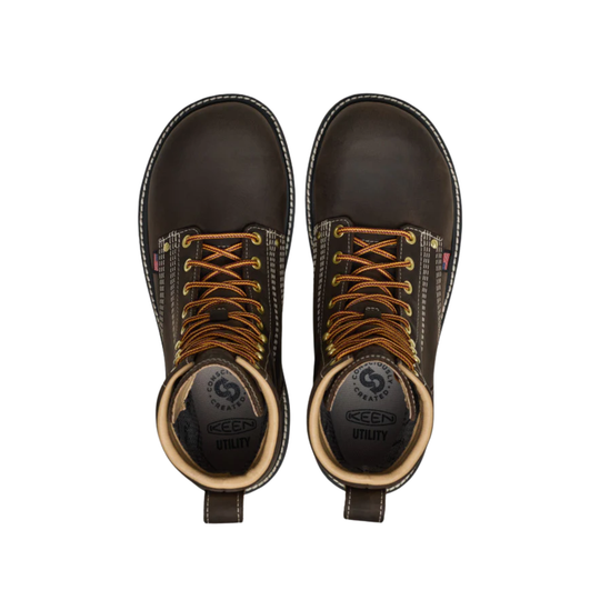 Pair of brown work boots with laces on a white background