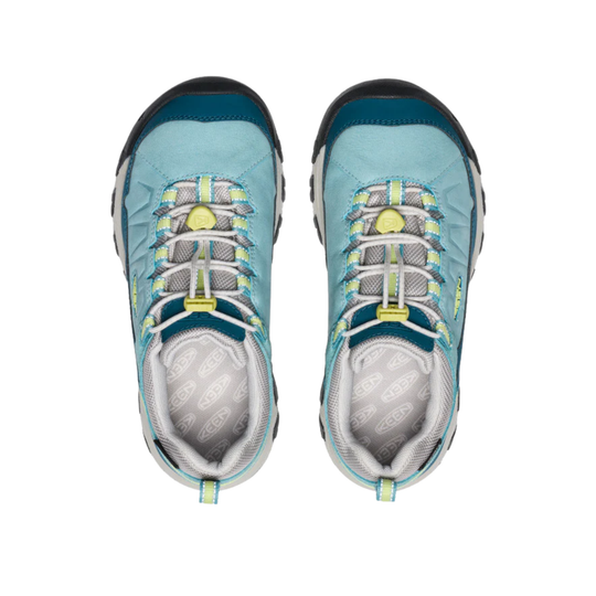 Pair of blue children's shoes with gray soles on a white background