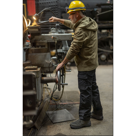 Man operating machinery in a workshop setting