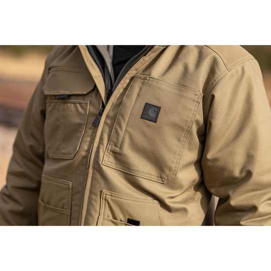 Beige jacket with a brand logo on a blurred background