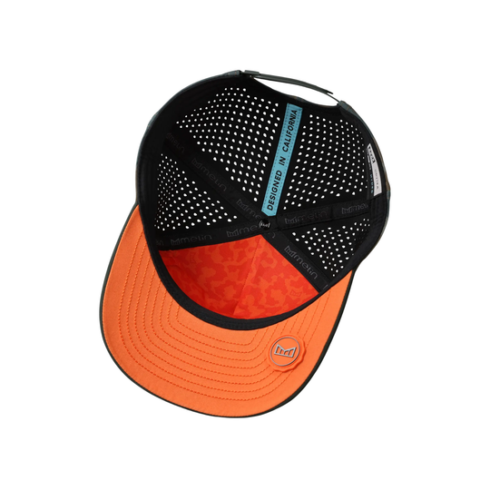 Black and orange cap with mesh back on a white background