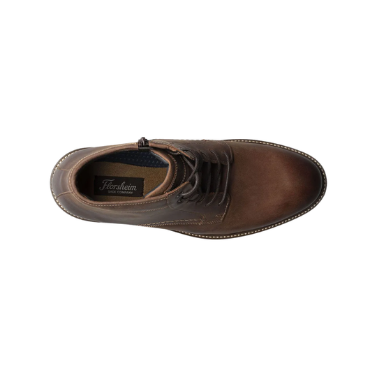 Brown leather shoe with laces on a white background