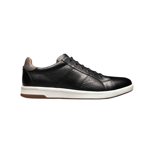Black leather sneaker with white sole on a white background