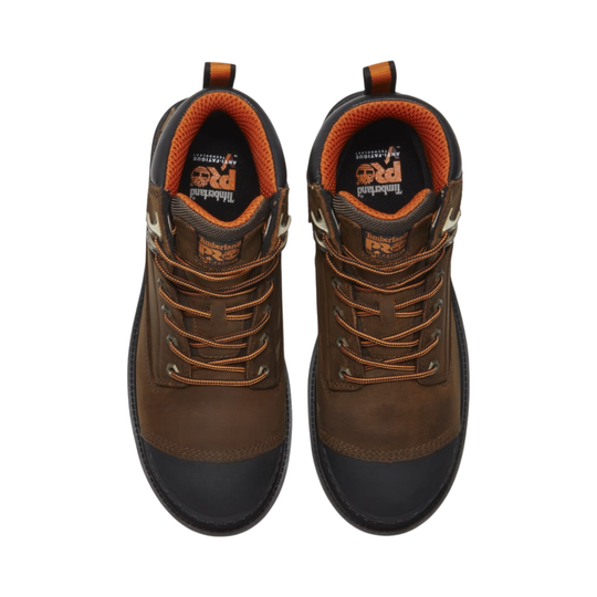 Pair of brown work boots with orange accents on a white background