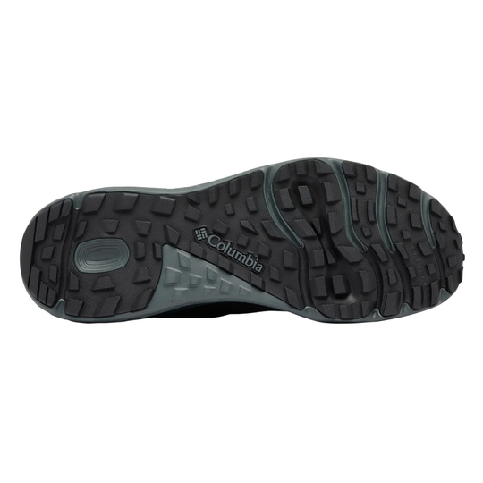 The outsole of a Columbia hiking shoe, showing a rugged black tread pattern with a gray heel section and the 'Columbia' brand name printed on it, set against a plain white background.