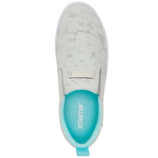 Light gray slip-on deck shoe with a turquoise insole and heel pull tab
