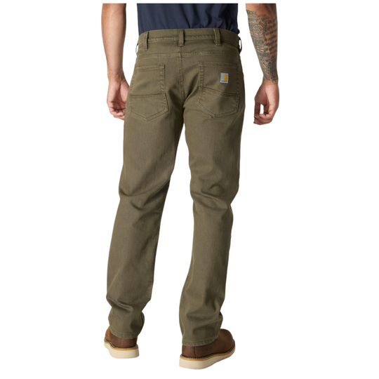 A man viewed from the back wearing a pair of olive green Carhartt work pants, a navy blue shirt, and brown shoes, against a plain white background.