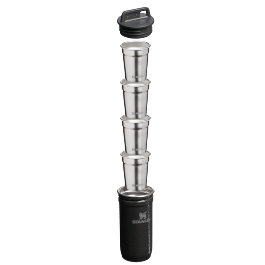 Stanley travel cup set with five nested stainless steel cups and a black lid, shown stacked vertically in a telescoping design inside a black sleeve on a white background.