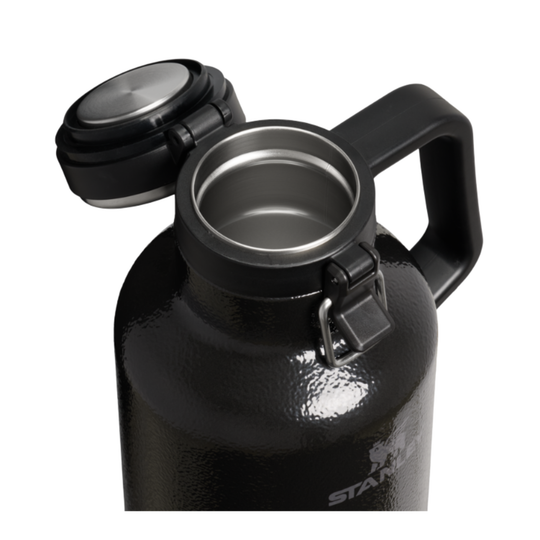 A black stainless steel growler with its lid off, showing the interior and a carry handle, on a white background.