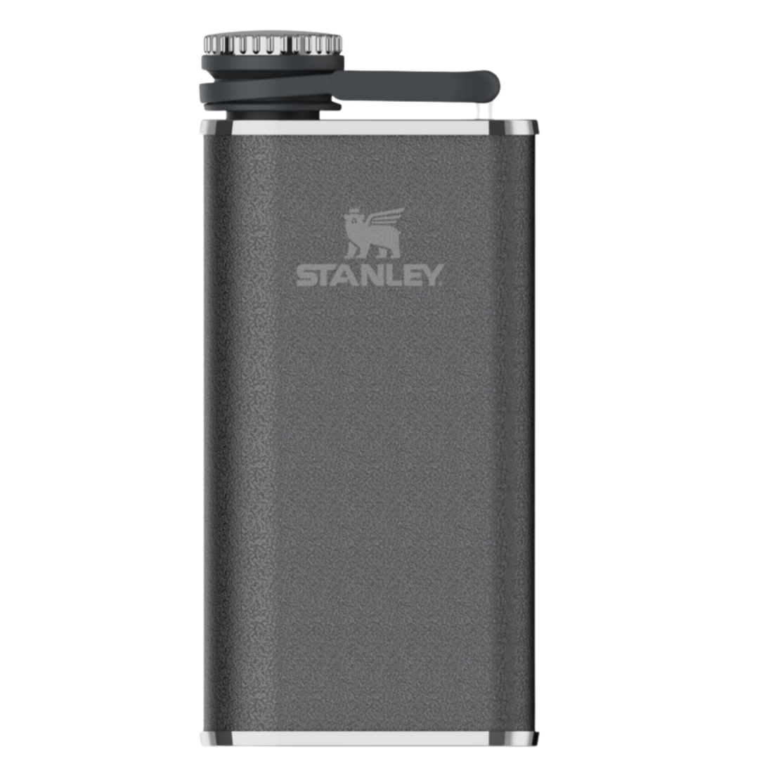 A dark gray textured Stanley flask with a silver metal rim, a black screw cap, and a black flip-top handle, shown on a plain white background.