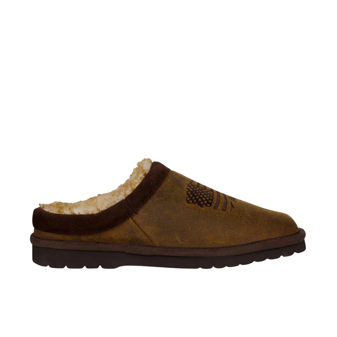 A single brown suede slip-on mule shoe with a dark brown trim and a cream-colored shearling lining, shown from a side profile on a white background.