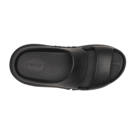 Black slide sandal shown from a top-down view, featuring a wide textured strap and a contoured sole with a visible 'CROCS' logo embossed on the footbed.