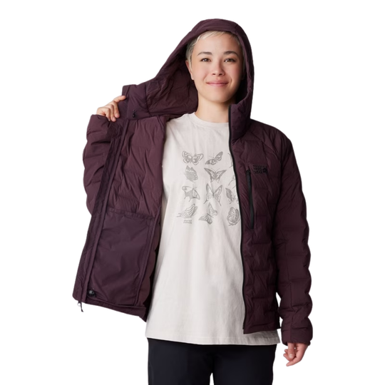 A person wearing a dark plum hooded puffer jacket over a white graphic t-shirt, shown against a plain white background.