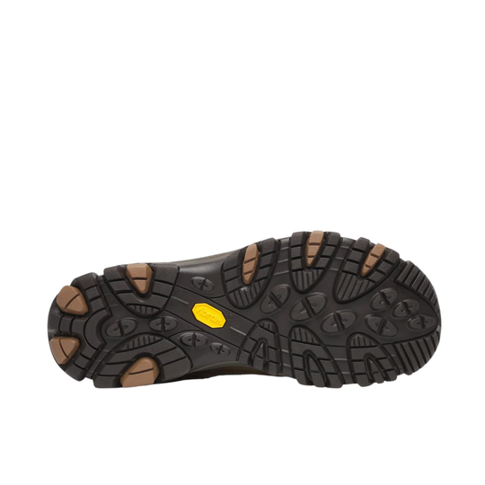 A close-up view of a black rugged shoe sole with brown lugs and a small yellow Vibram logo, shown against a plain white background.