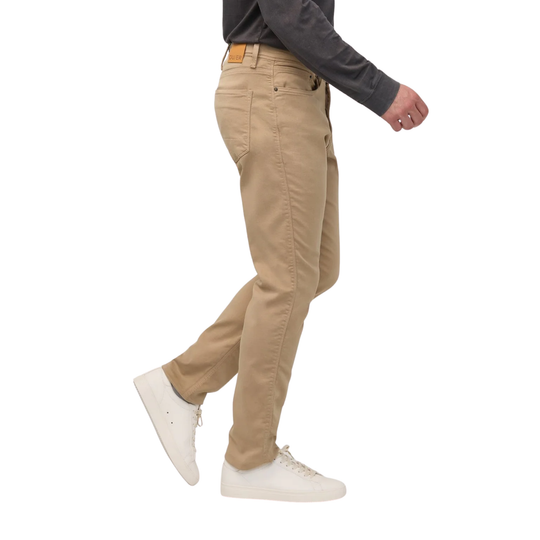 A side profile view of a person wearing khaki chinos, a dark gray long-sleeve shirt, and white sneakers against a plain white background.