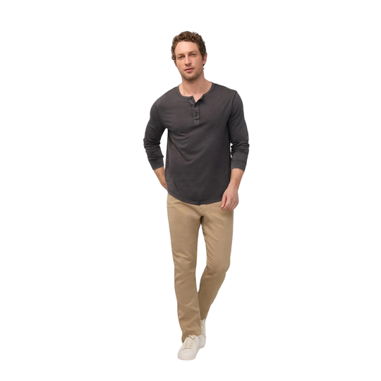 A man modeling a dark gray long-sleeve henley shirt with beige pants and white sneakers, standing against a plain white background.