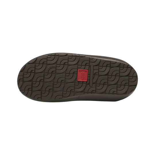 The bottom sole of a dark brown shoe, featuring a textured geometric tread pattern and a small red square logo patch in the center, shown against a plain white background.