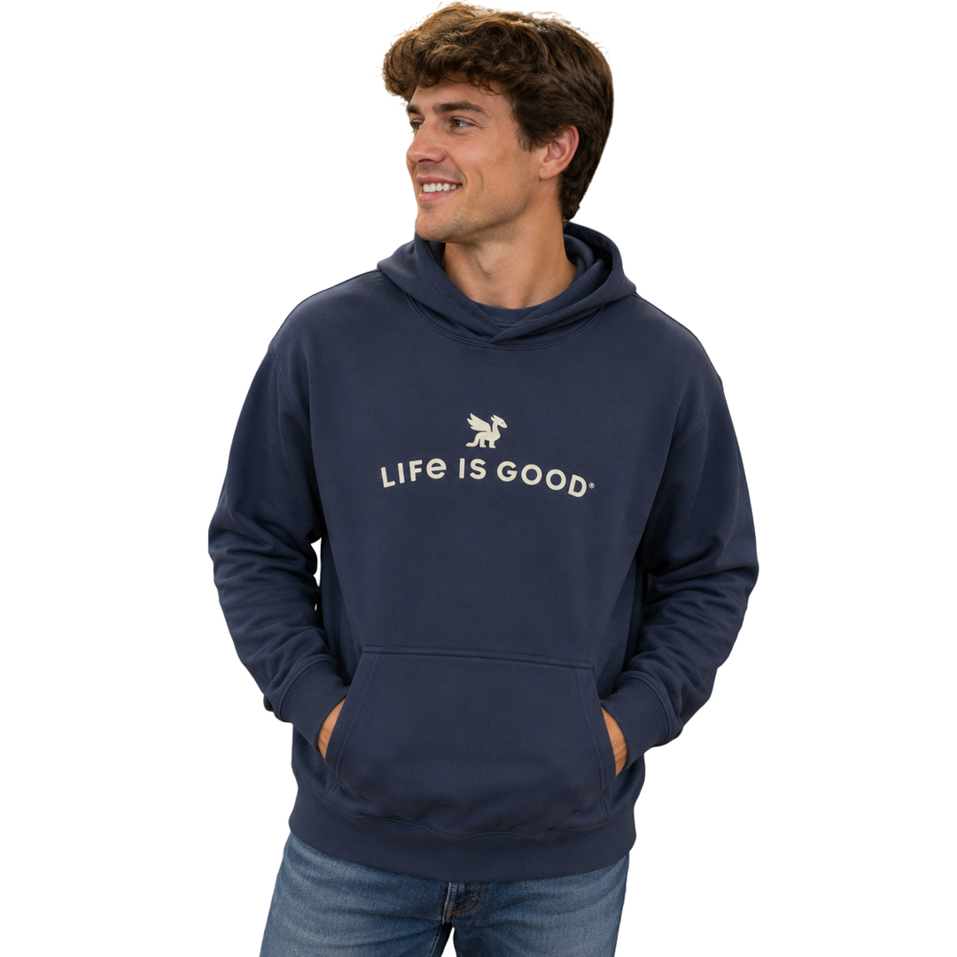 A man wearing a navy blue hoodie with 'LIFE IS GOOD' printed in white across the chest, paired with blue jeans, set against a plain white background.