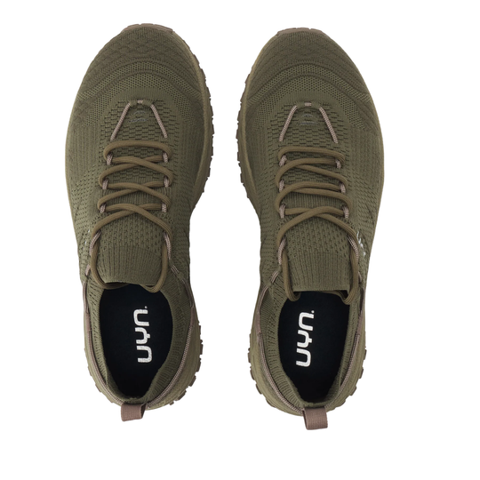 A pair of olive green knit slip-on sneakers shown from a top-down view on a plain white background. The shoes feature matching olive laces, a black interior lining with the white 'uyn' logo, and a small pull tab at the heel.