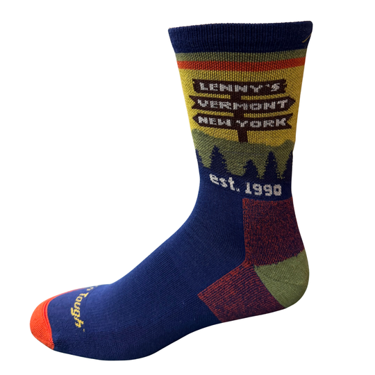 A single crew sock with a navy blue body, a yellow and green mountain landscape graphic on the upper section, and 'Darn Tough' written in yellow on the toe cap, set against a plain white background.