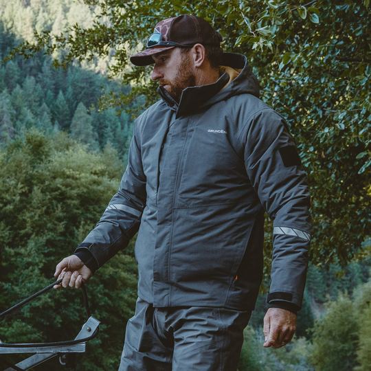 Grundens Men's Transmit X Insulated Jacket - Dark Anchor on male model on wilderness forest background